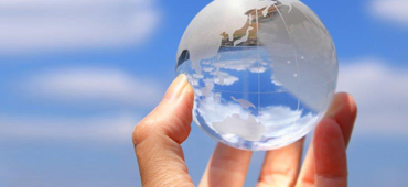 hand holding glass globe